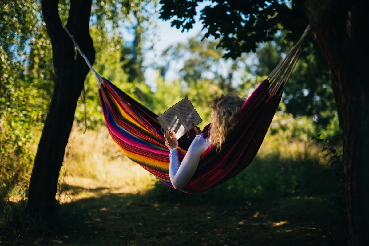 chilling in a hammock reading