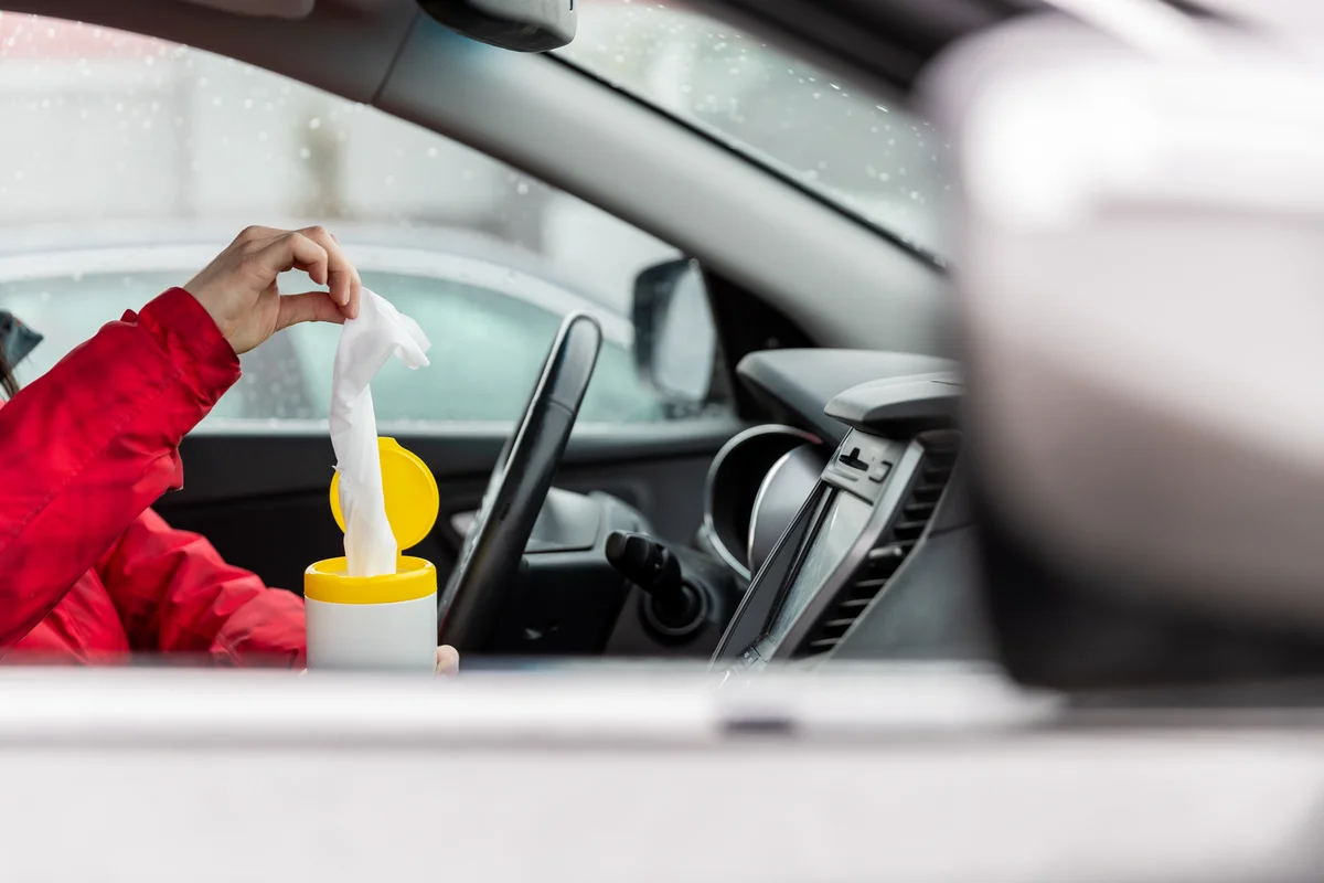 using a wipe to clean the car's interior