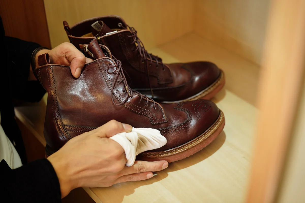 person wiping shoes