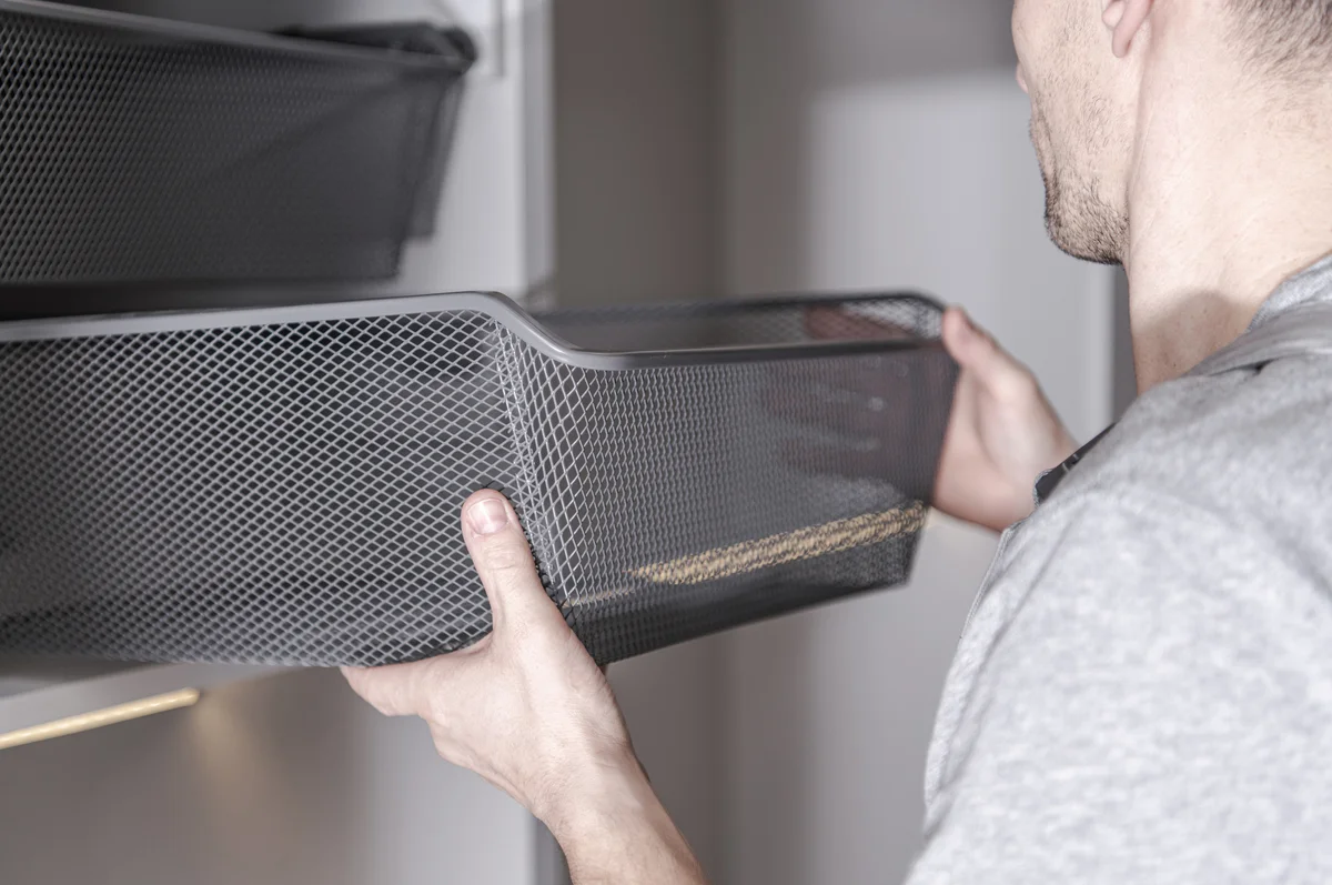 Man using metal drawers in garage
