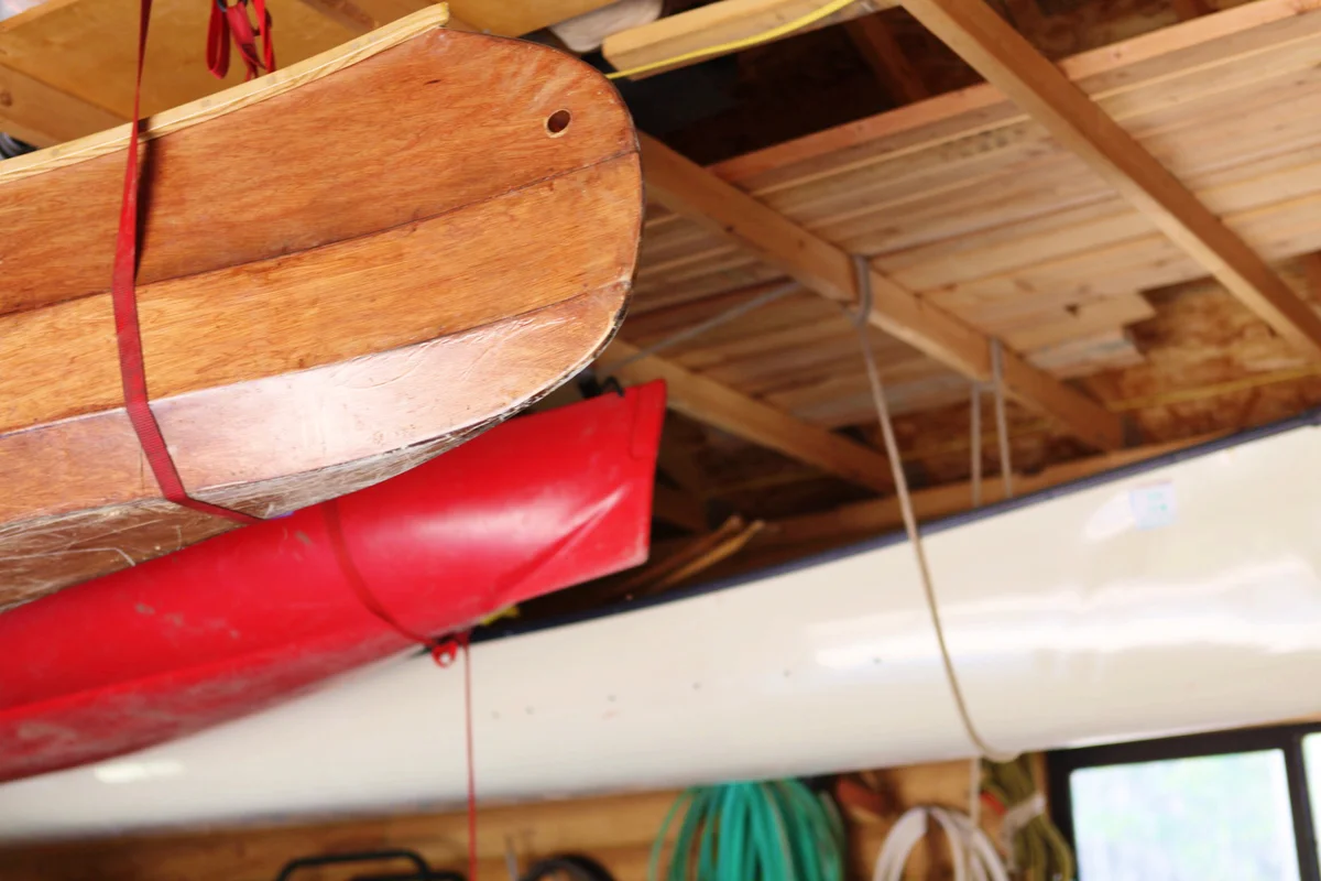 Canoes hanging from garage rafters