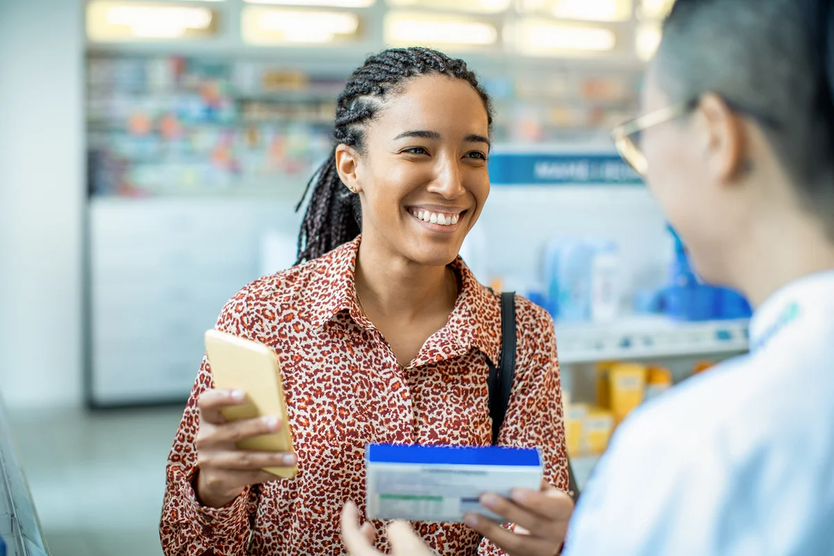 Pharmacist helping a customer choose a product