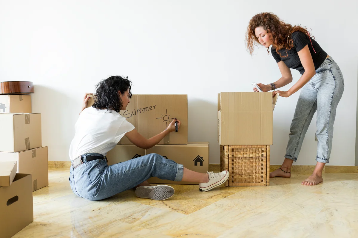 two women labeling boxes