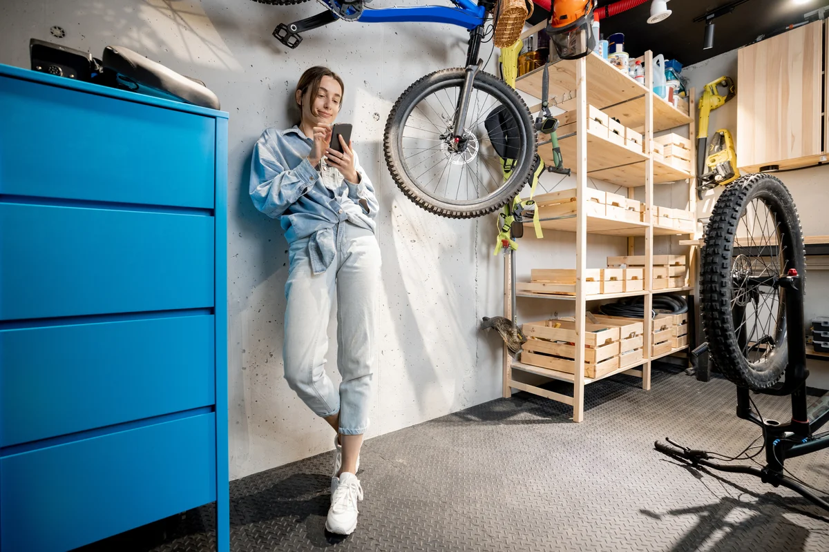 Woman standing in organized garage with storage