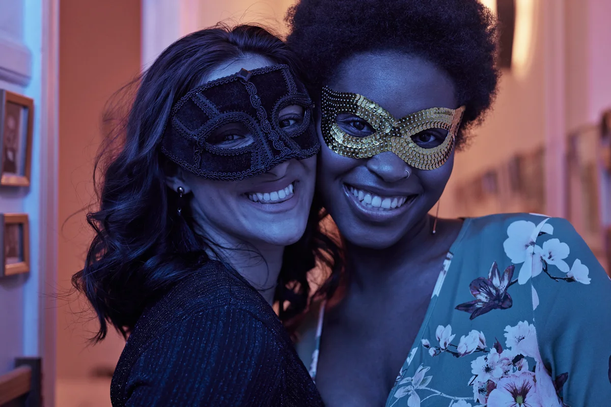 two women wearing masks
