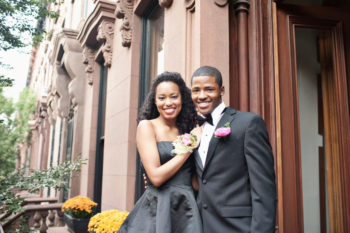Young couple taking photo on front patio with pretty background
