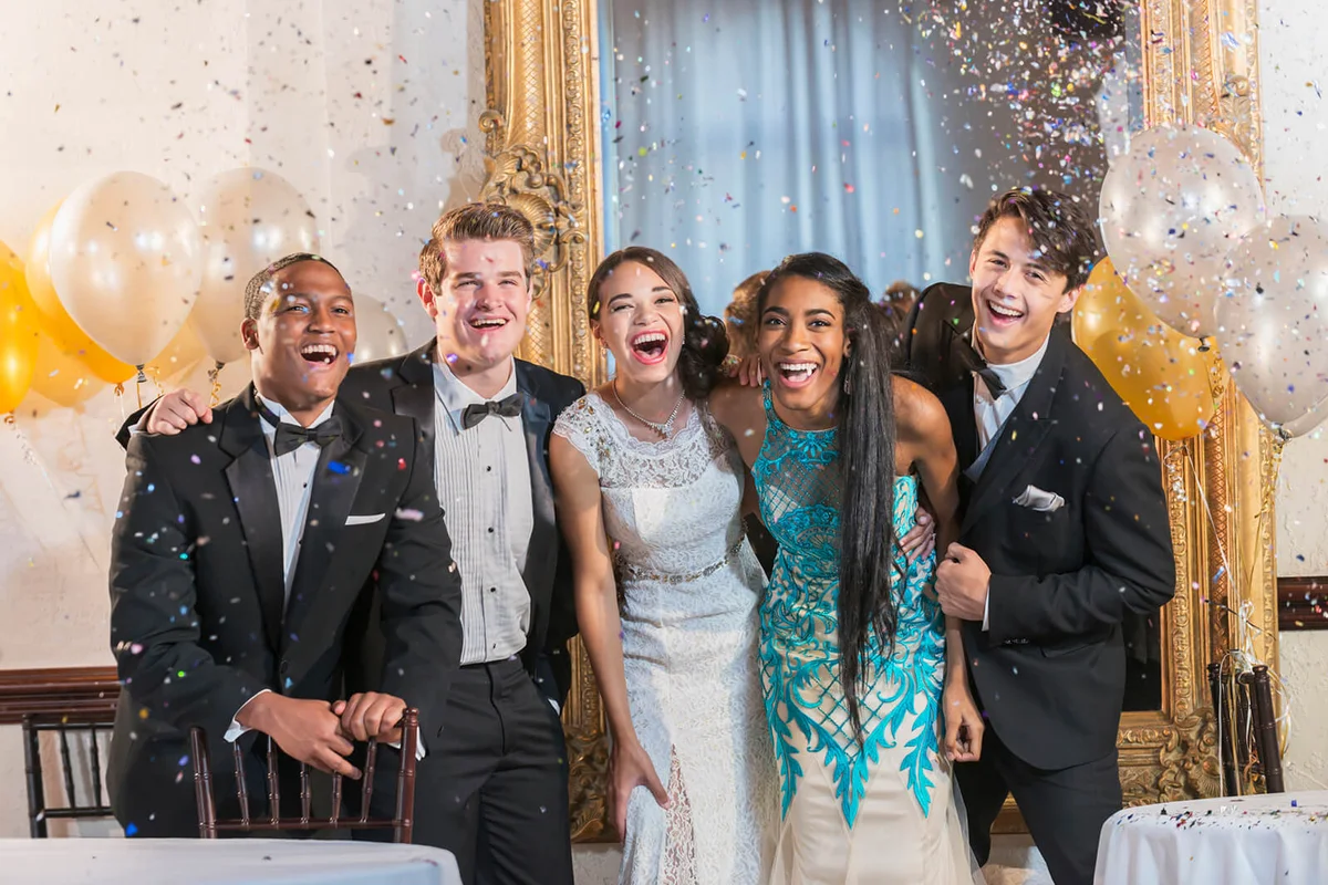 Teenagers and young adults in formalwear at party