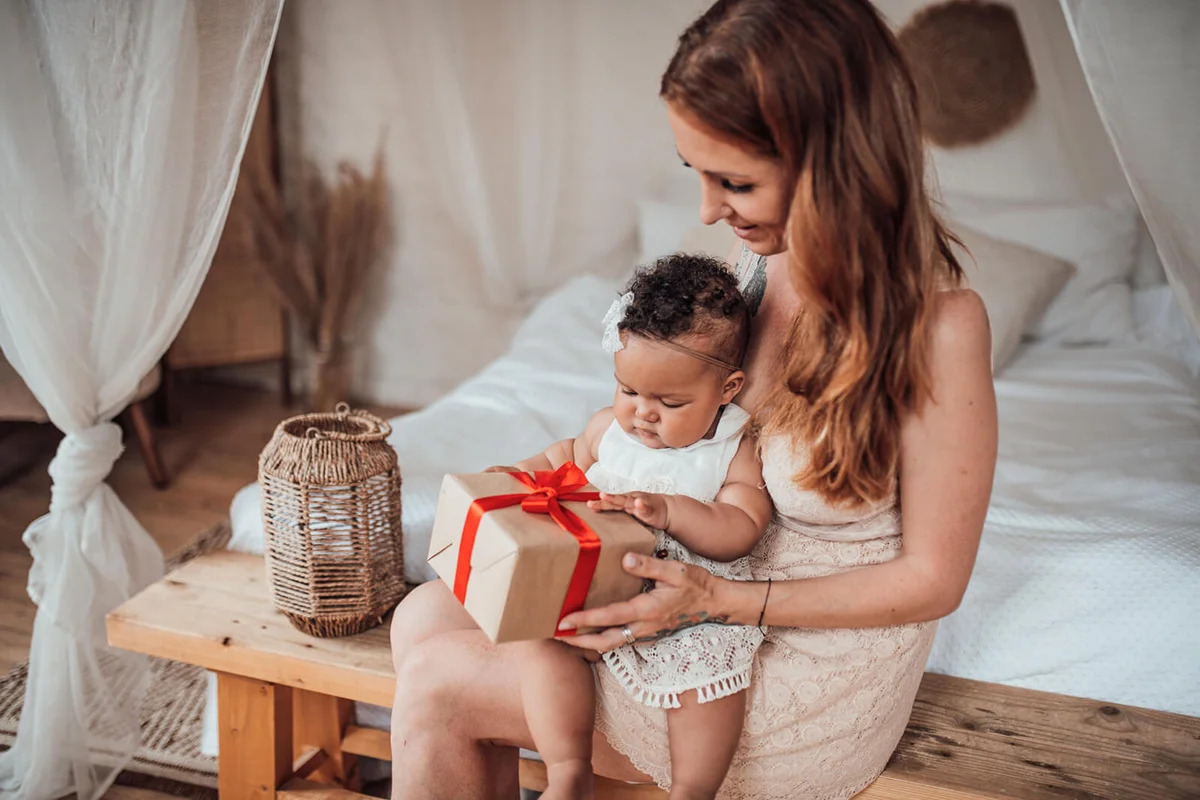 Baby girls receiving a gift