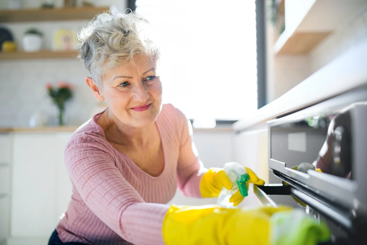 woman cleaning ovens