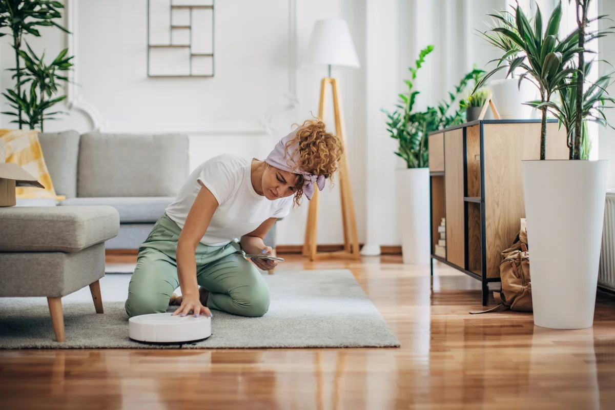 woman cleaning her roomba