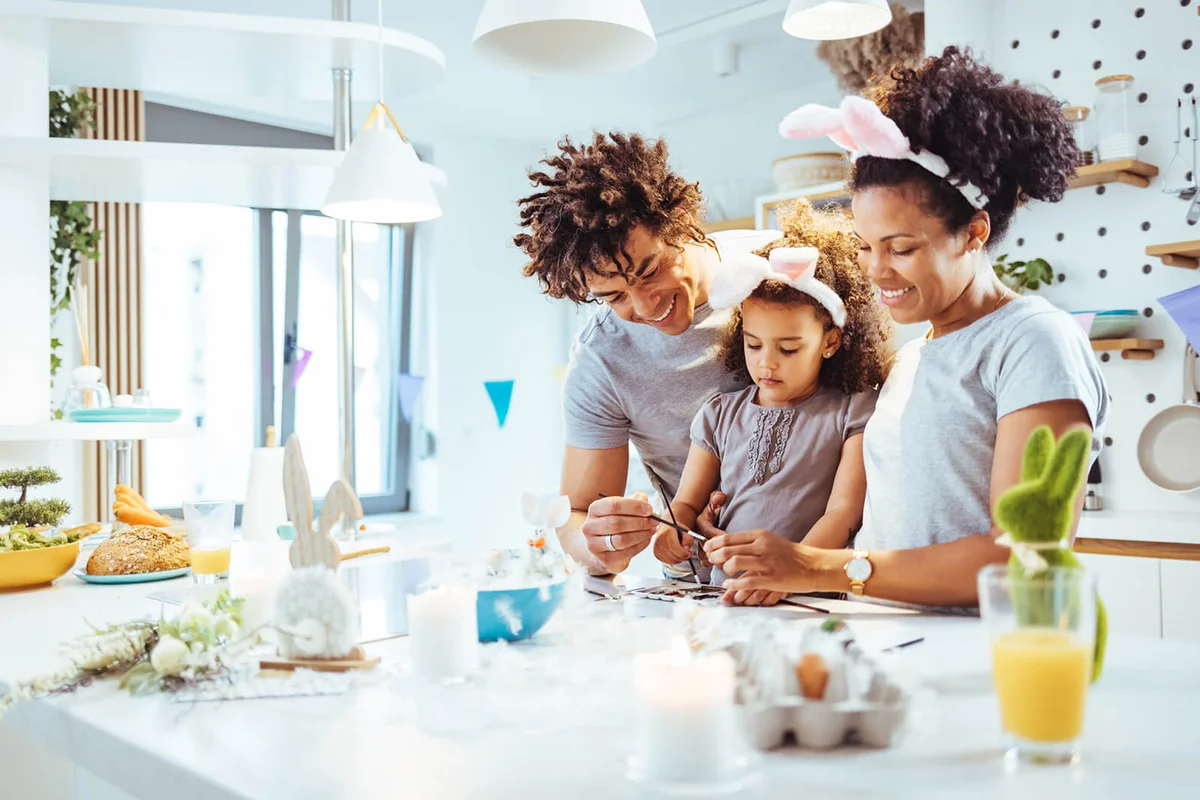 family painting Easter eggs together