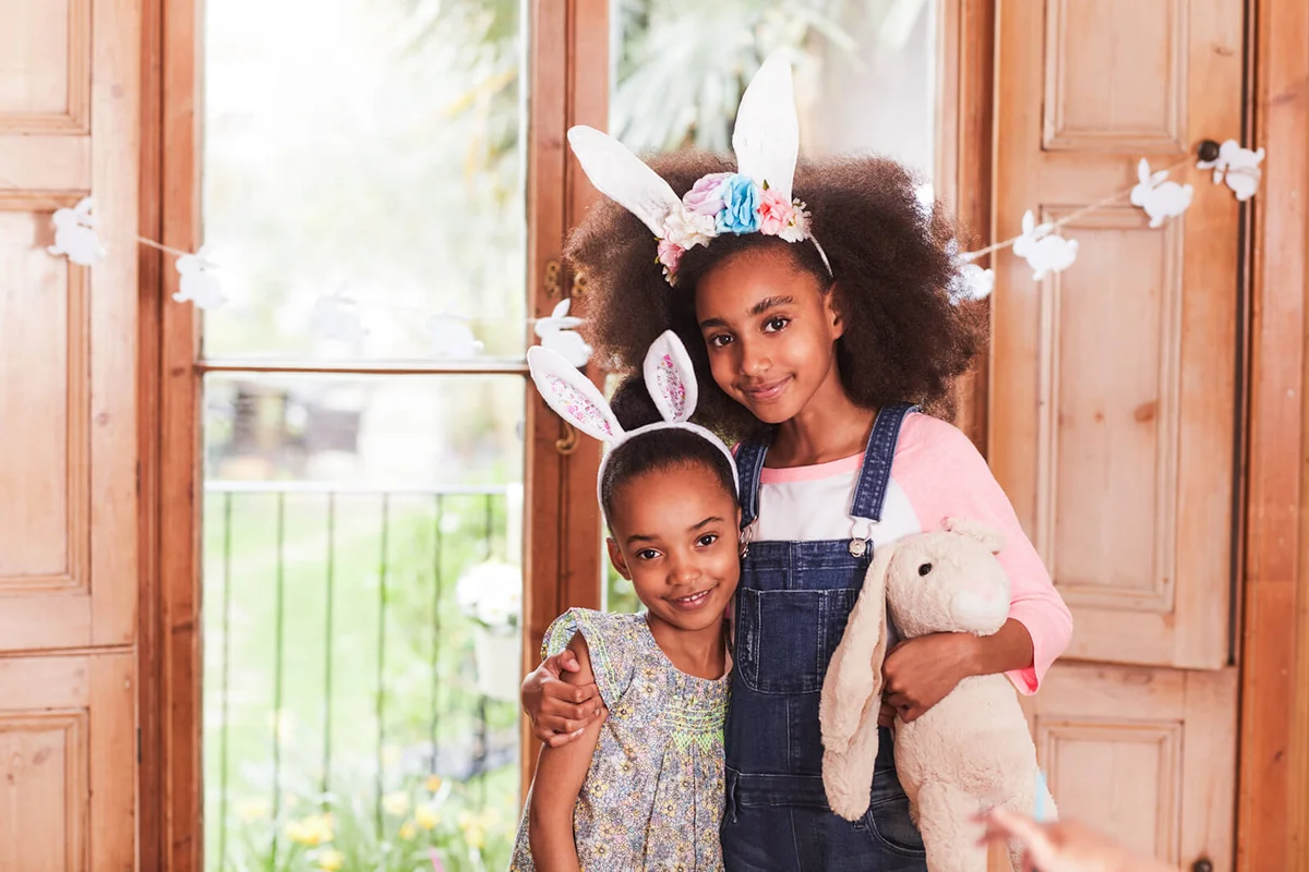 Two children hugging wearing Easter bunny ears