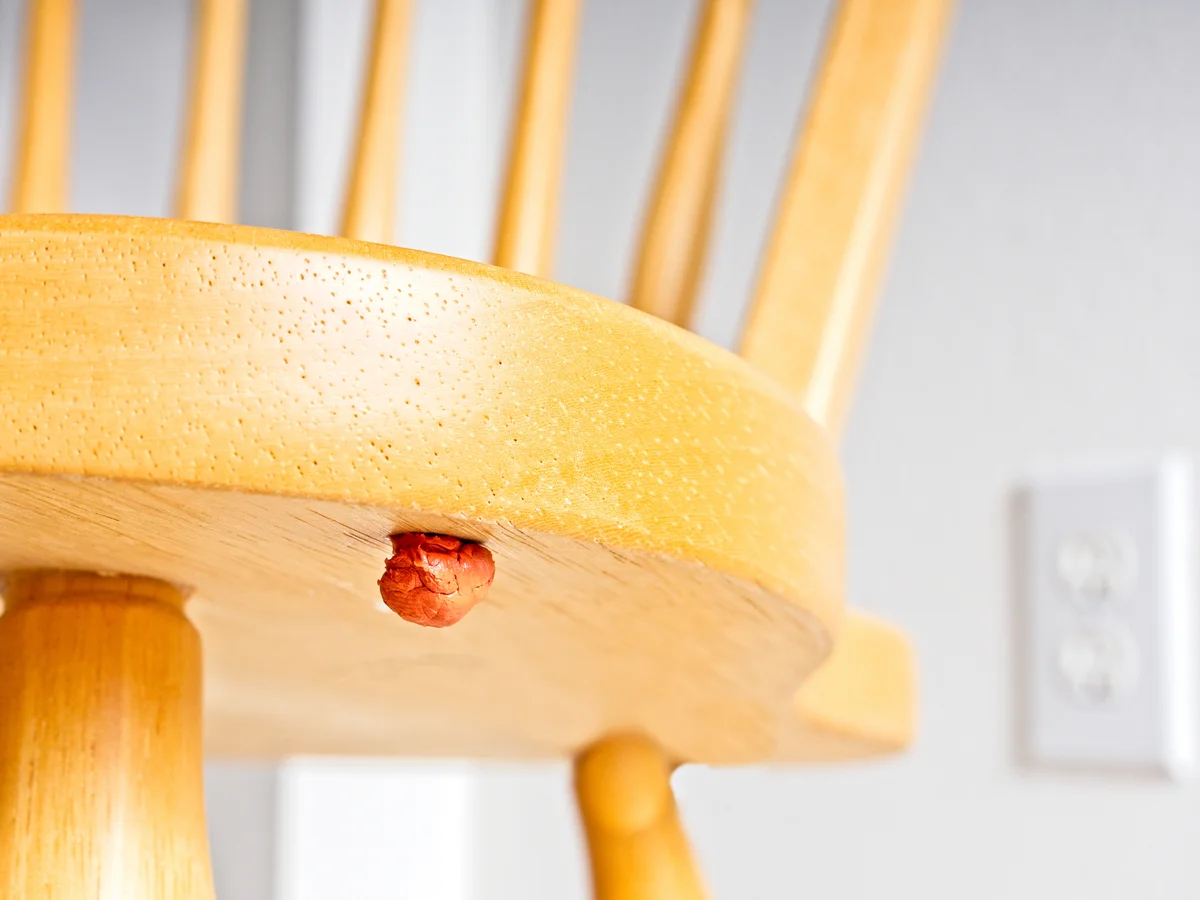gum stuck to the bottom of a chair