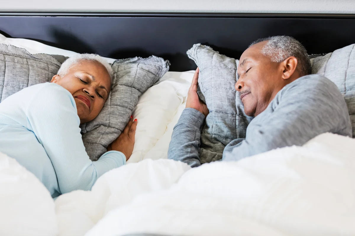 Old couple sleeping soundly in bed