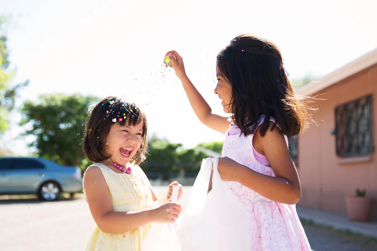 Girl cracks easter egg on girl's head