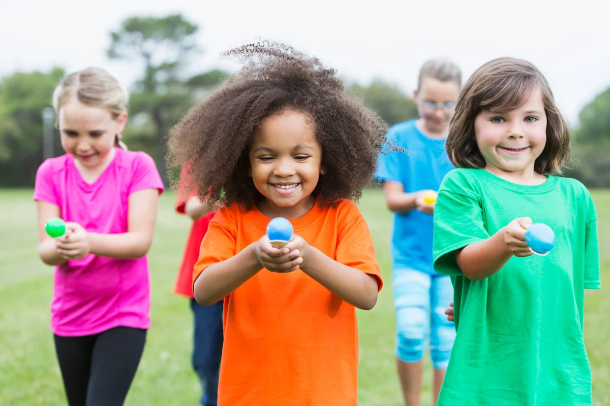 group of children in an egg spoon race