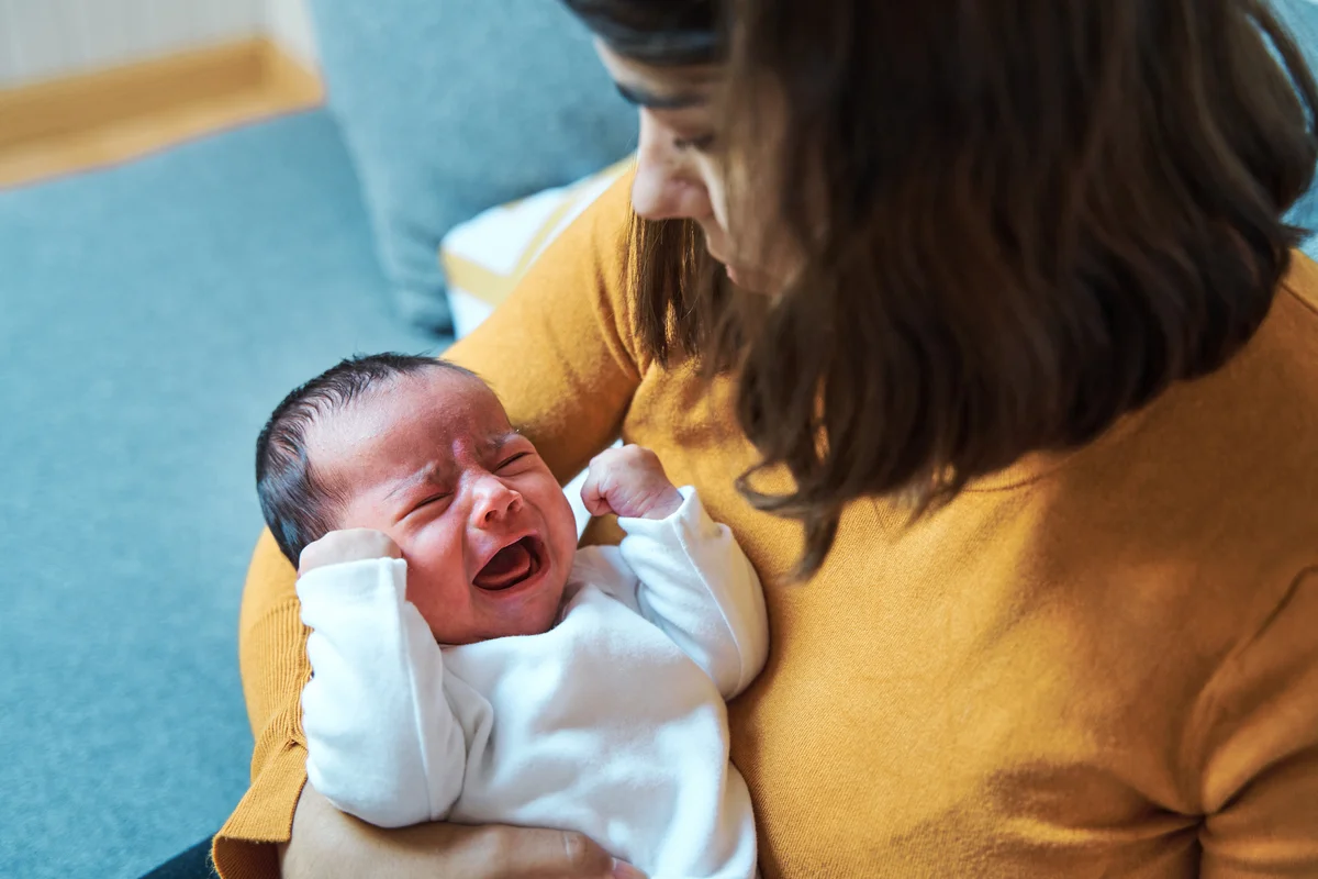 Mom cradling crying baby