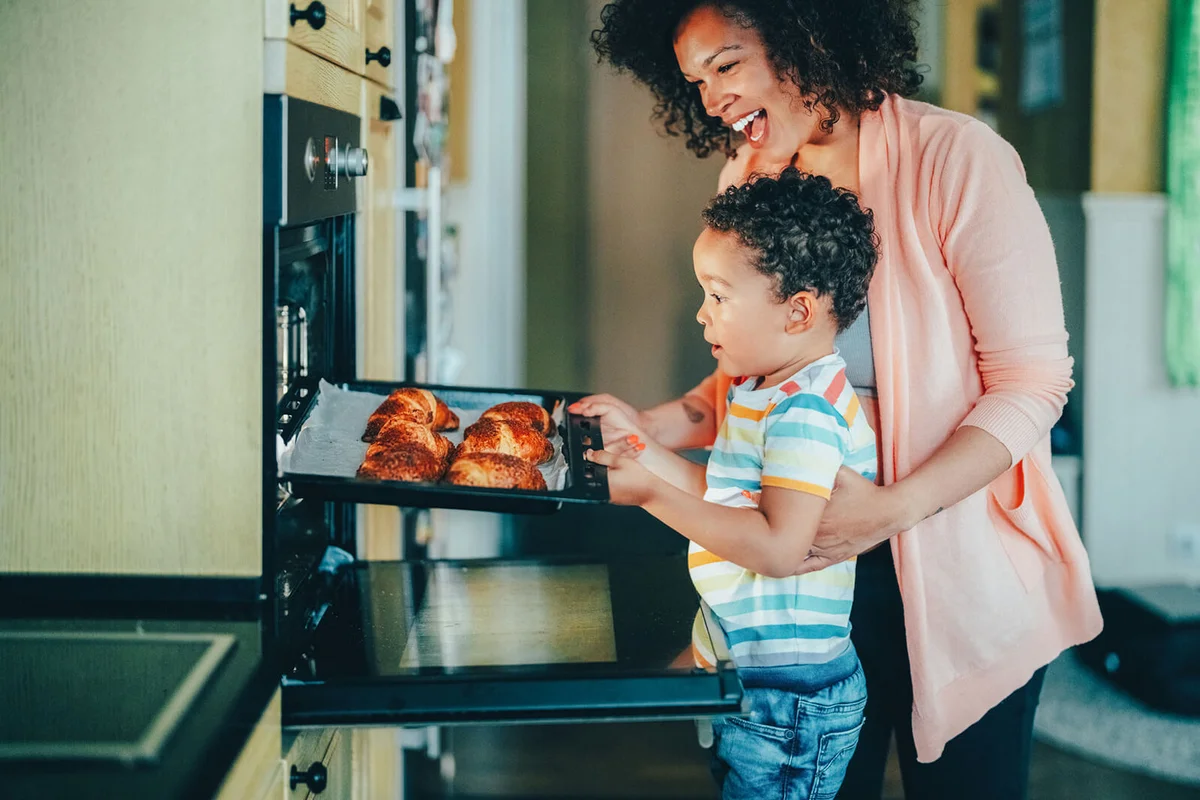 mother and son baking croissants in the kitchen
