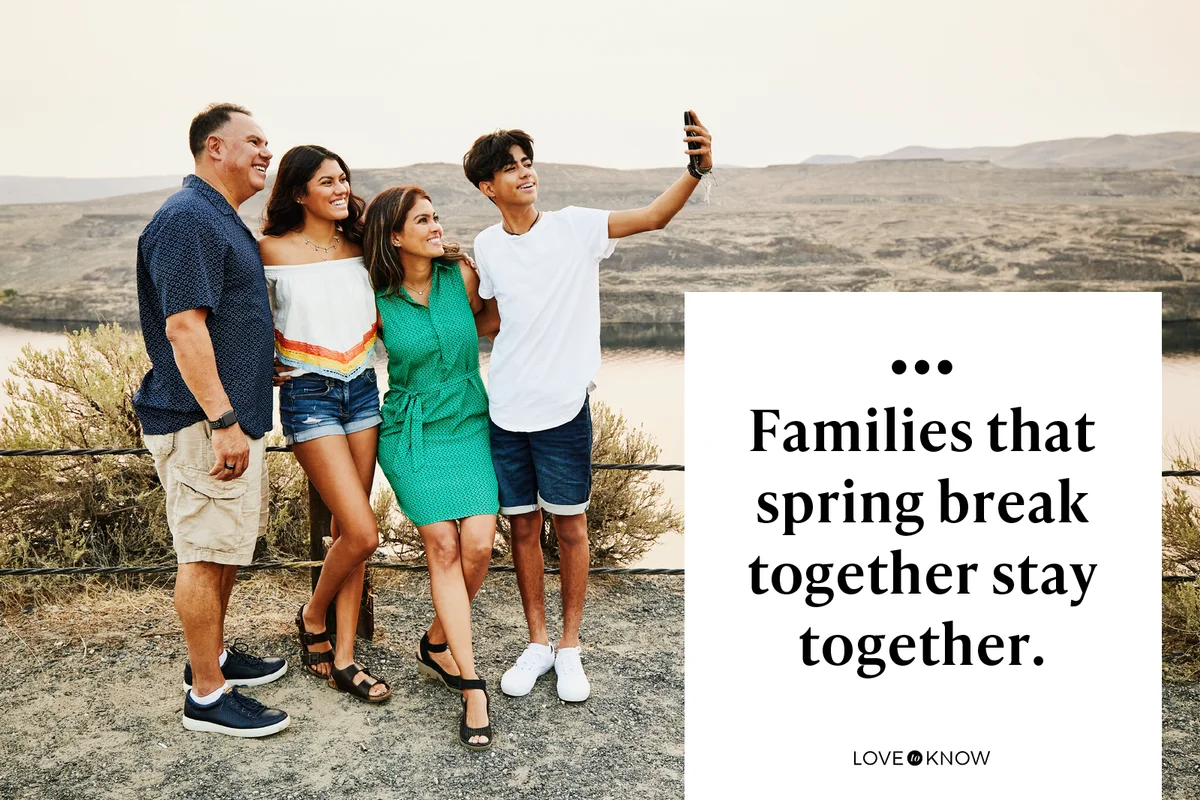 Smiling family taking selfie with smart phone during summer vacation