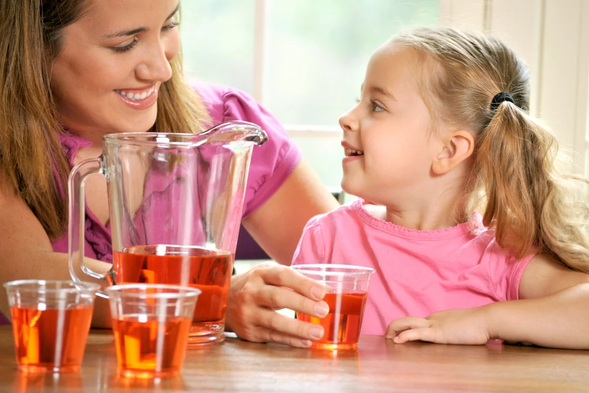 Mother and daughter making paint water punch