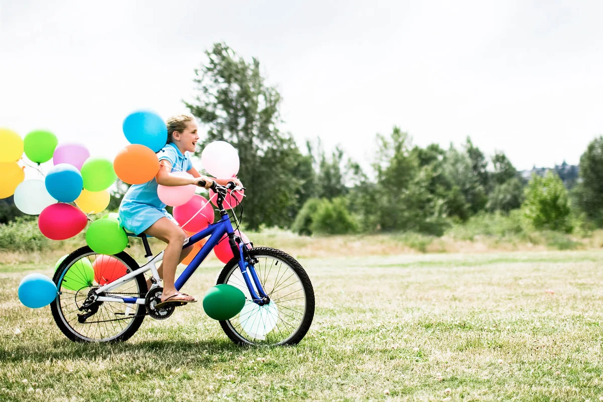 Girl on a Bike with Balloons
