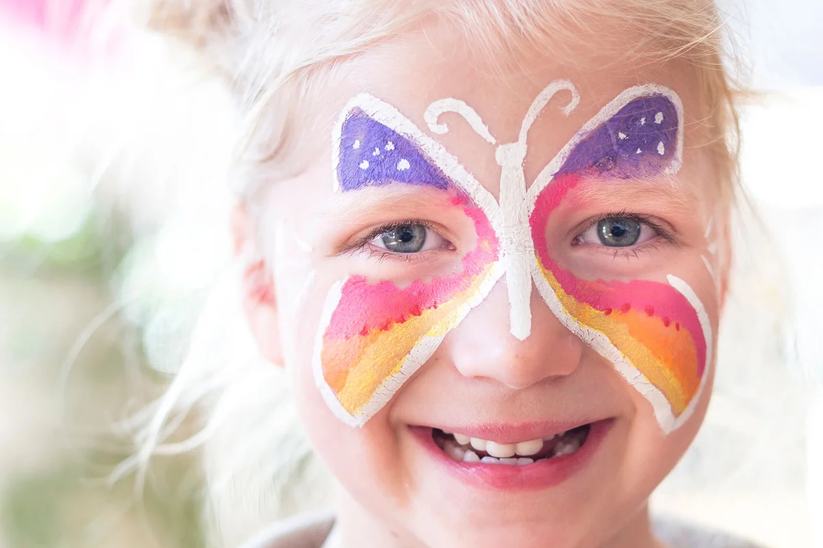 Smiling Girl With Painted Butterfly On Face