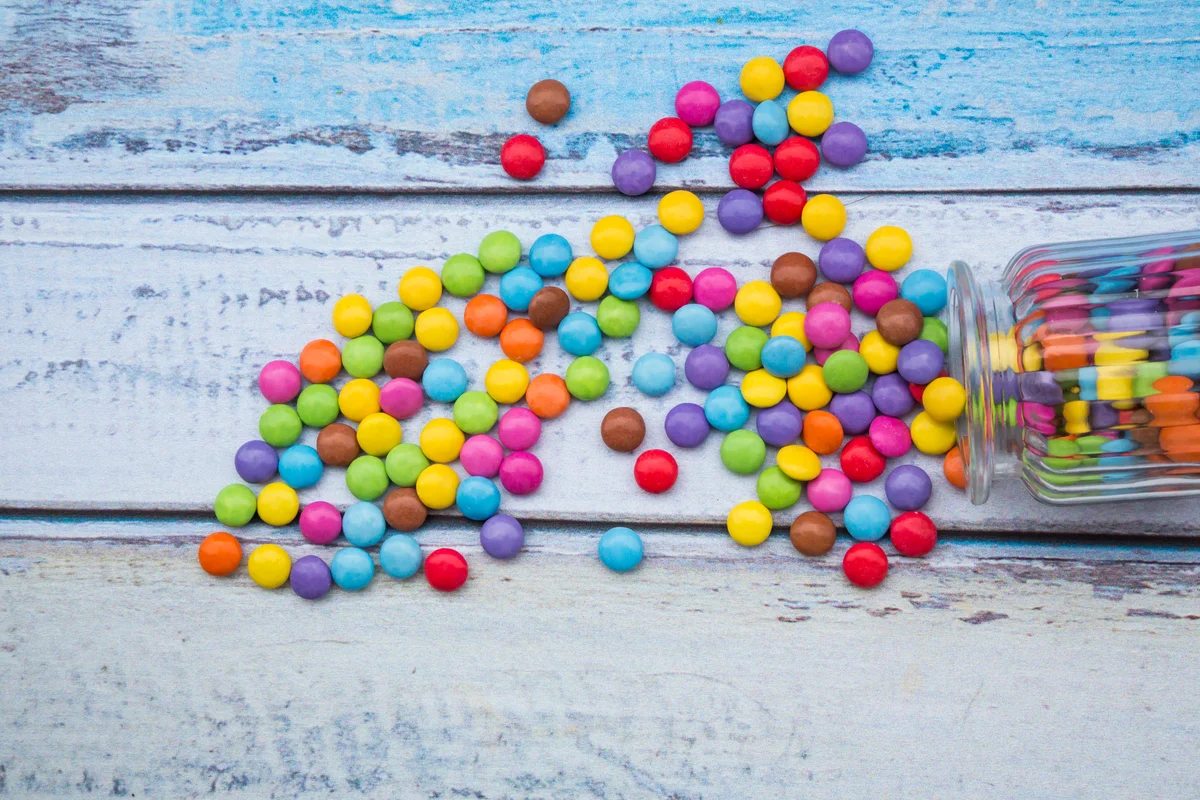 Smarties candies on blue background