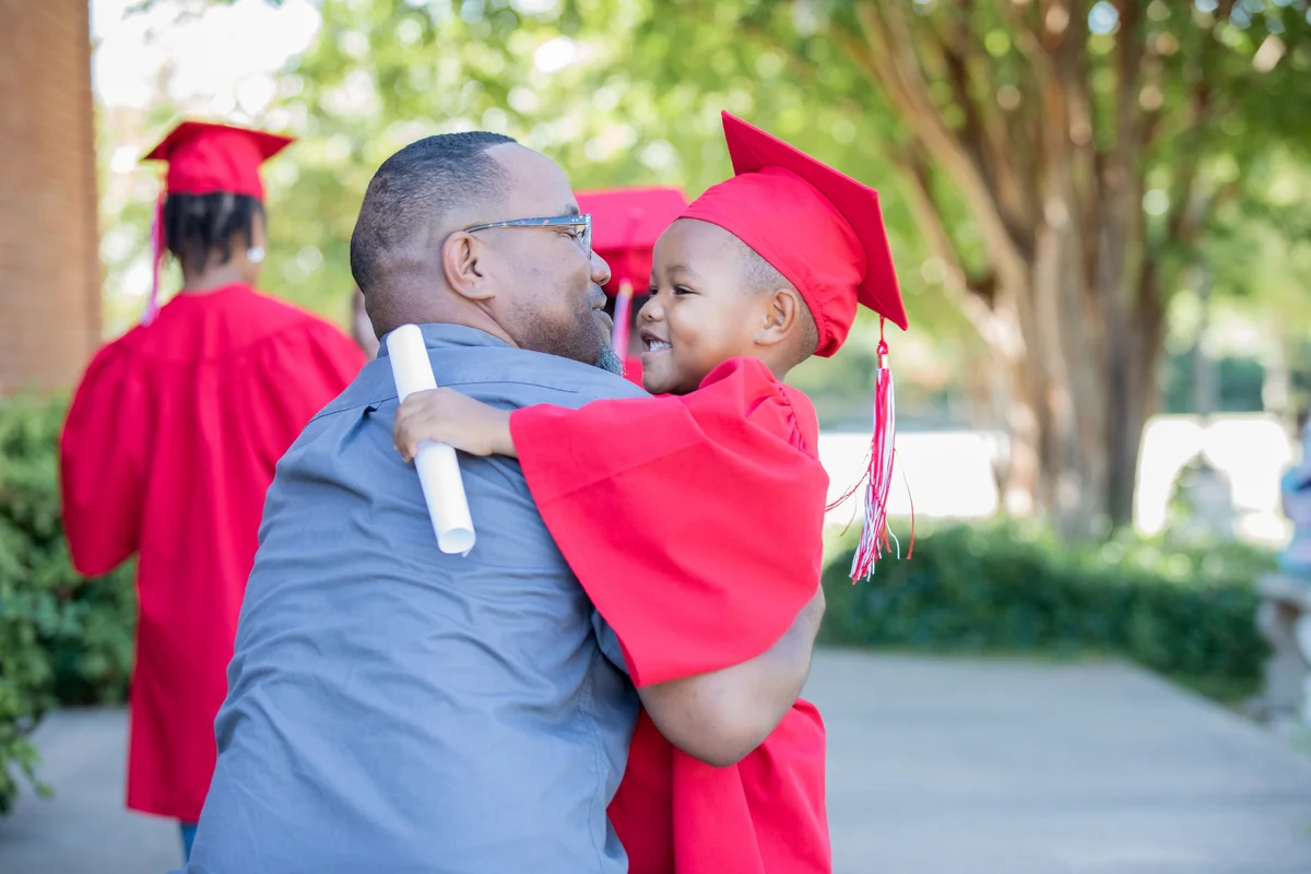 young grad hugging his dad