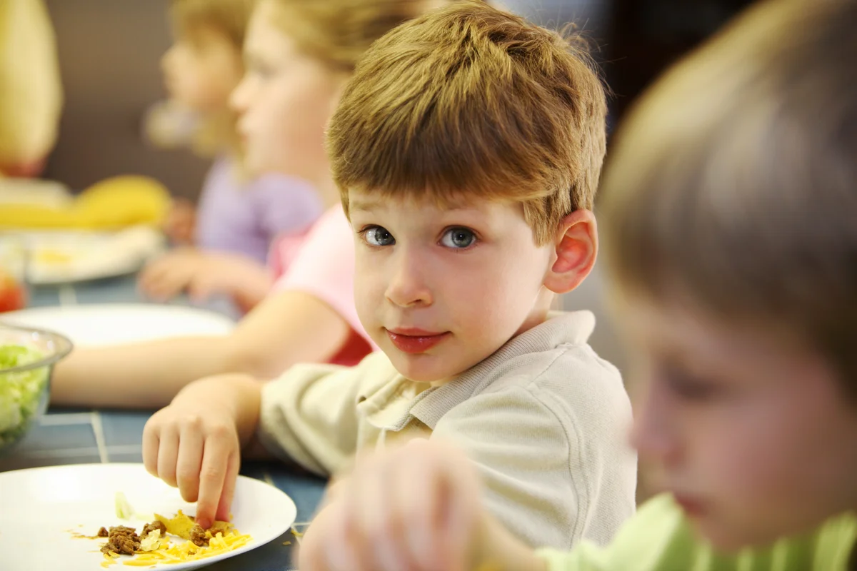 little boy eating taco