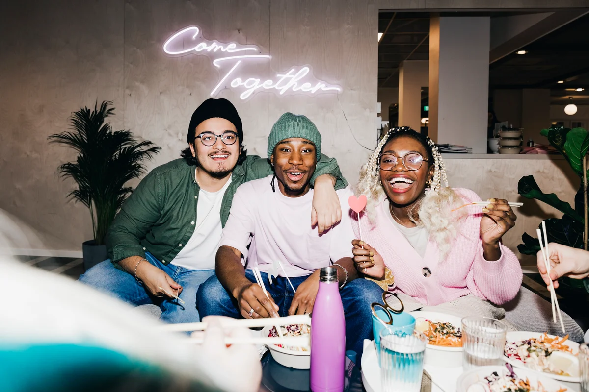 people at party with neon sign
