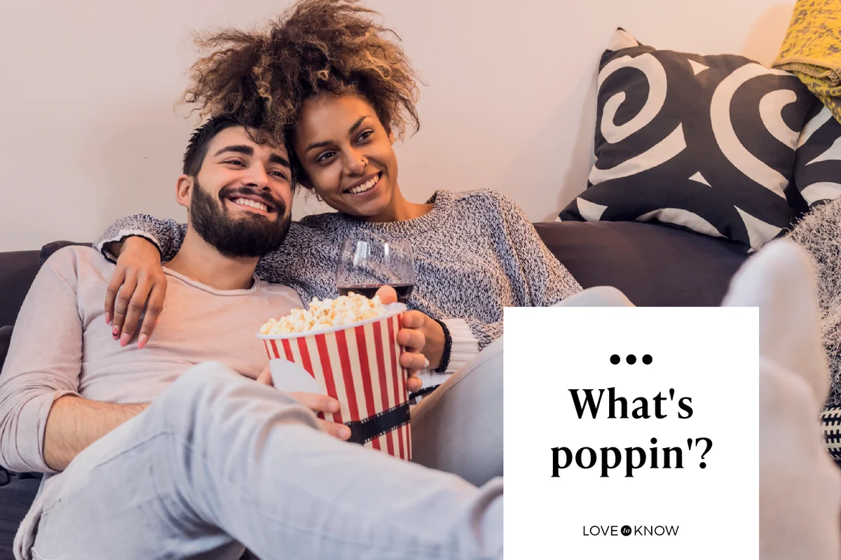 young couple sitting on living room sofa watching a movie