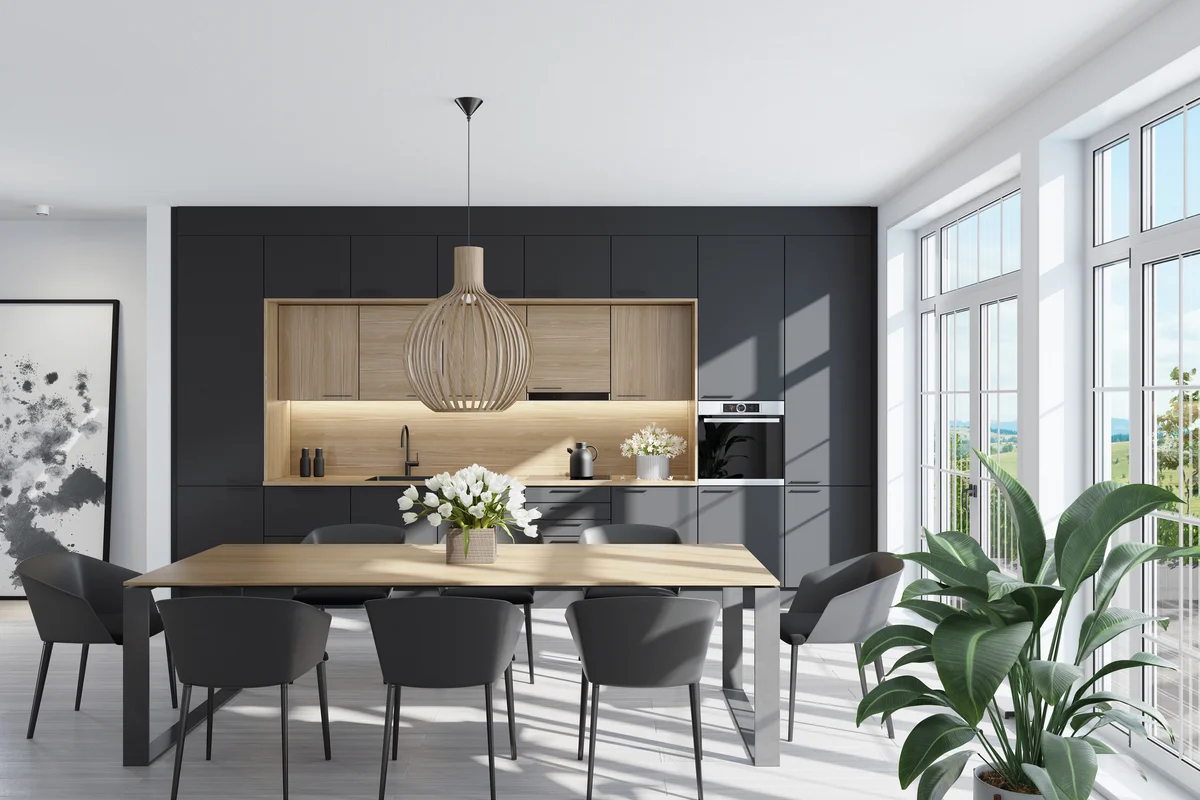 Trendy Scandinavian open concept kitchen and dining room with lots of natural light. Functional, modern and bright one wall kitchen with black and wooden cabinets.