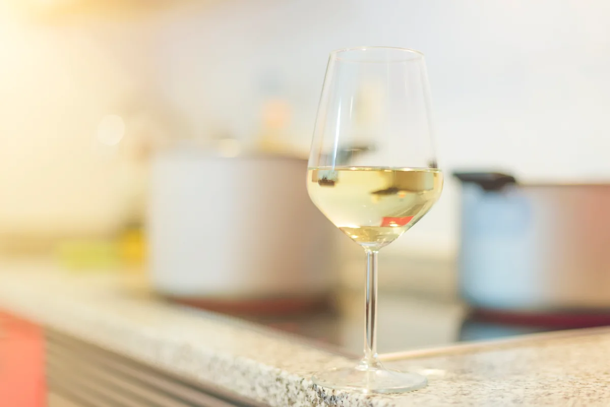 Glass of white wine in kitchen