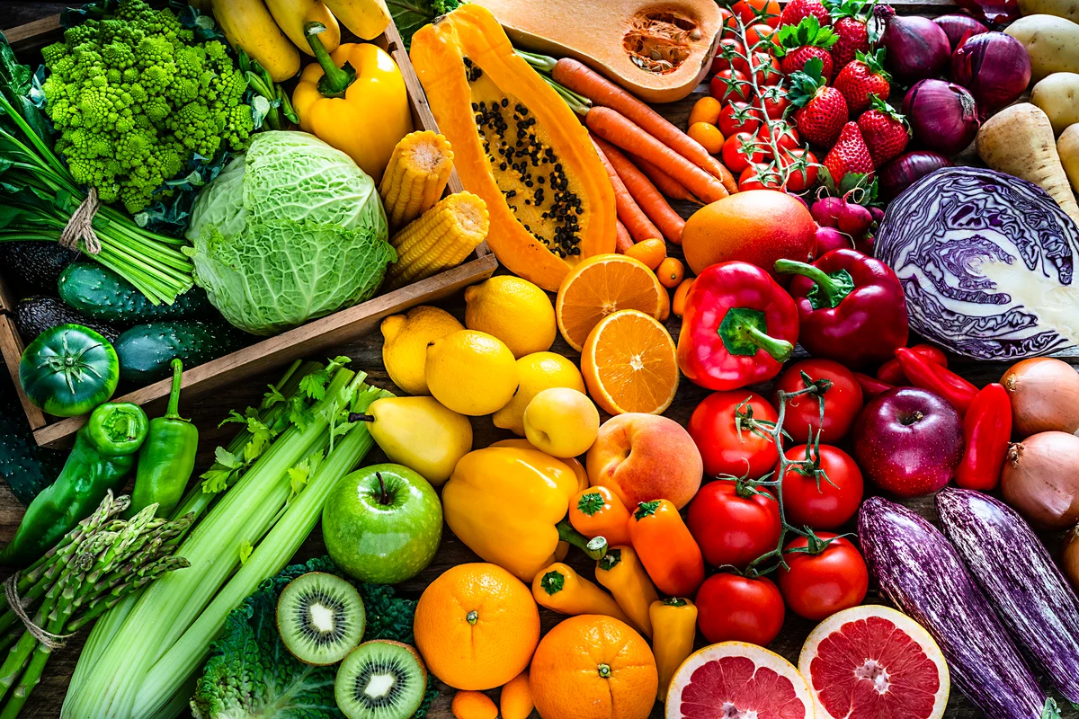 assortment of colorful produce fruits and veggies in rainbow order