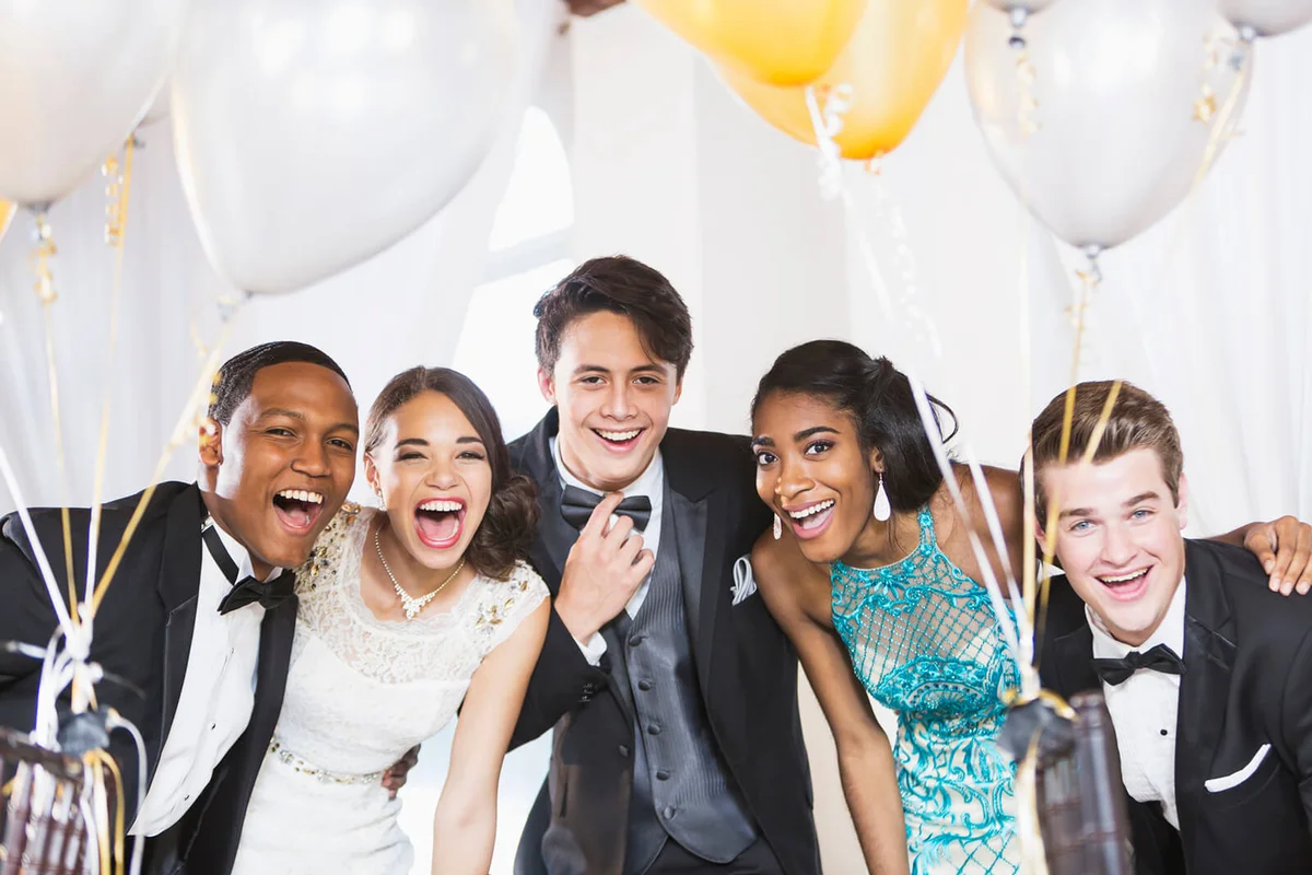 Five happy teenagers at formal party