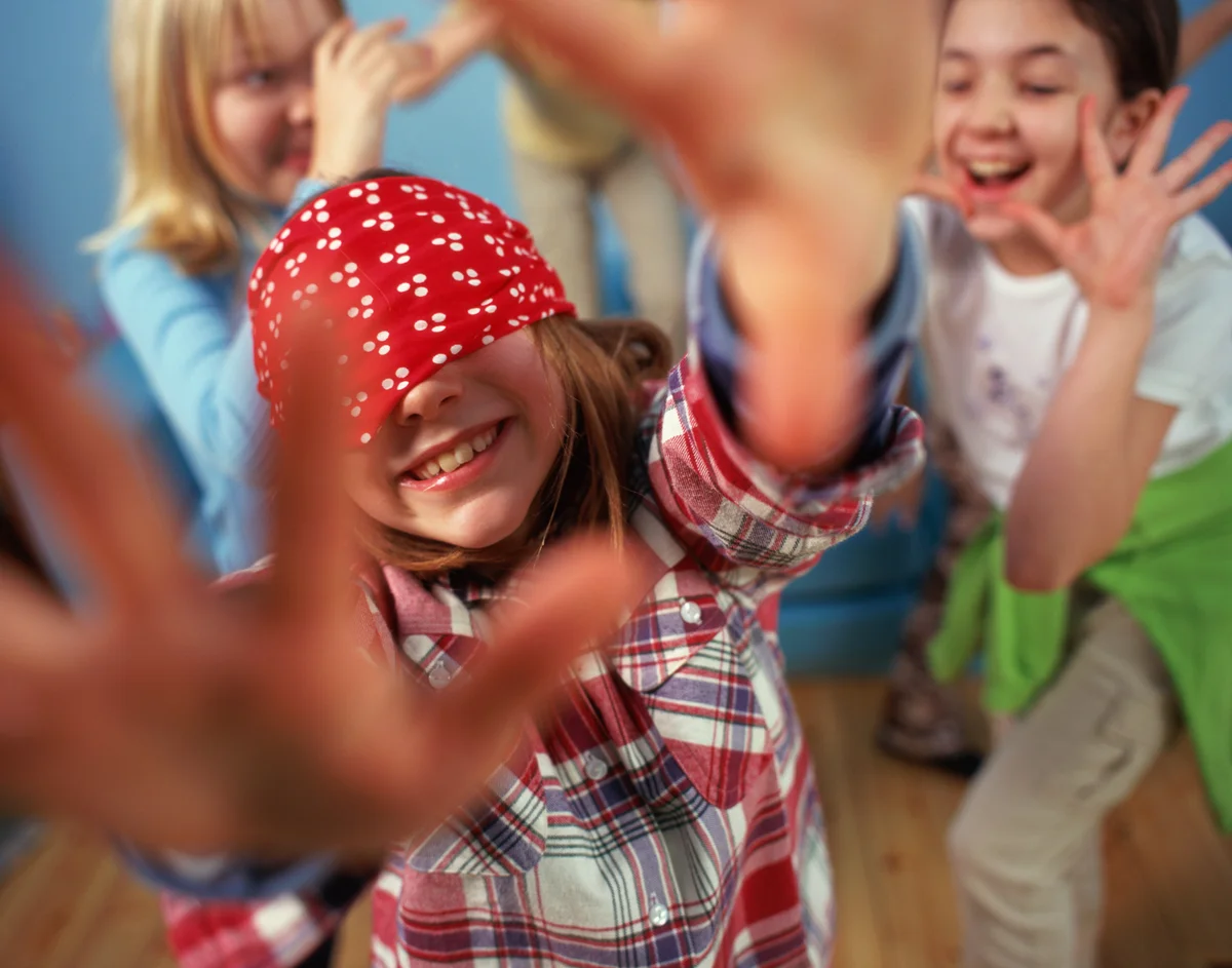 little girl wearing a blindfold