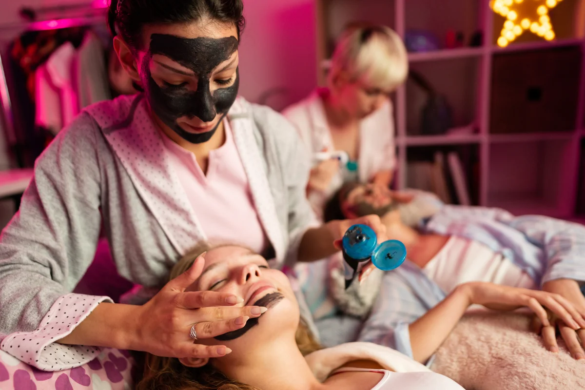 Group of friends enjoying at-home spa treatment and facial masks