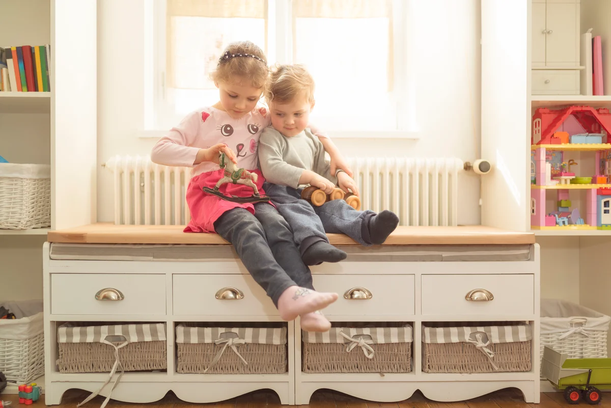 cute kids on a window seat