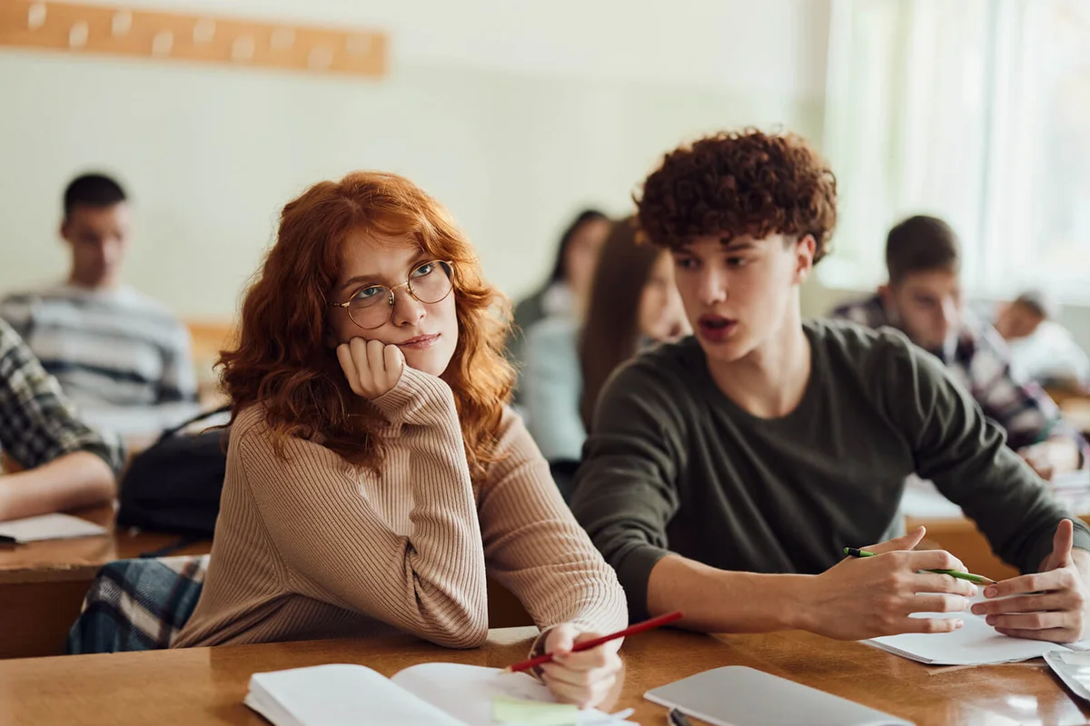 Careless female student ignoring her friend