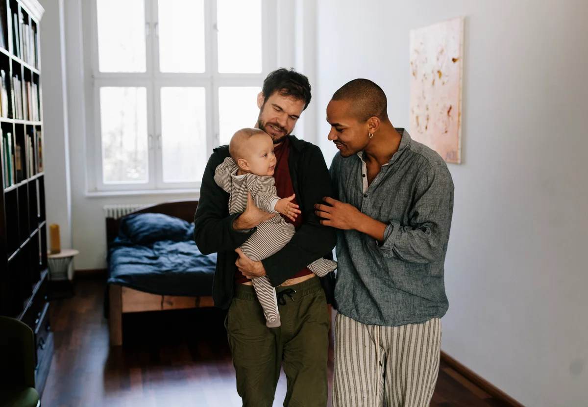 Dads holding their baby and talking closely with it