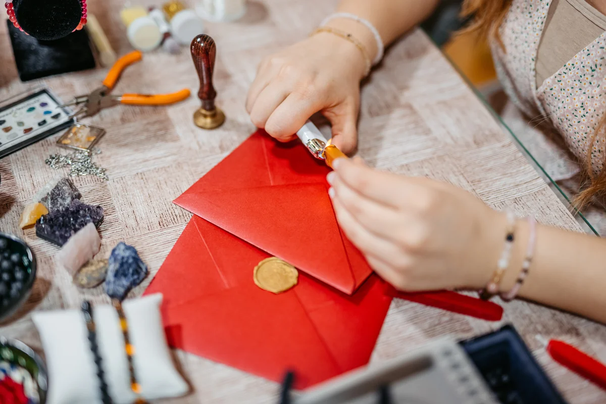 Woman sealing envelopes with wax