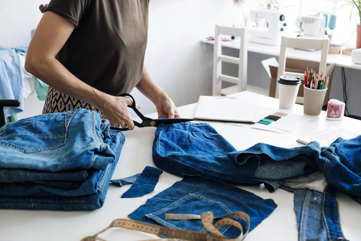 Woman upcycling jeans to make new clothes