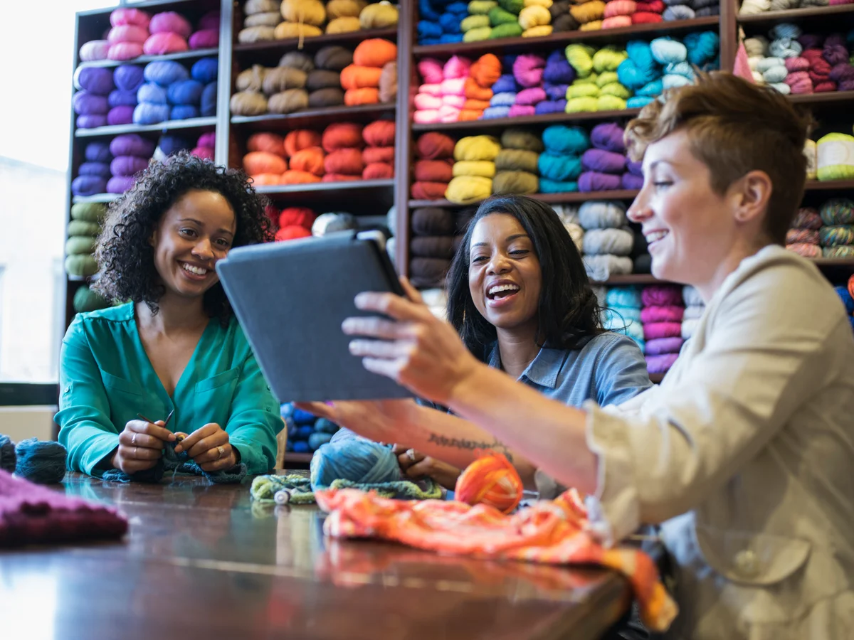 Women in yarn shop learning to knit