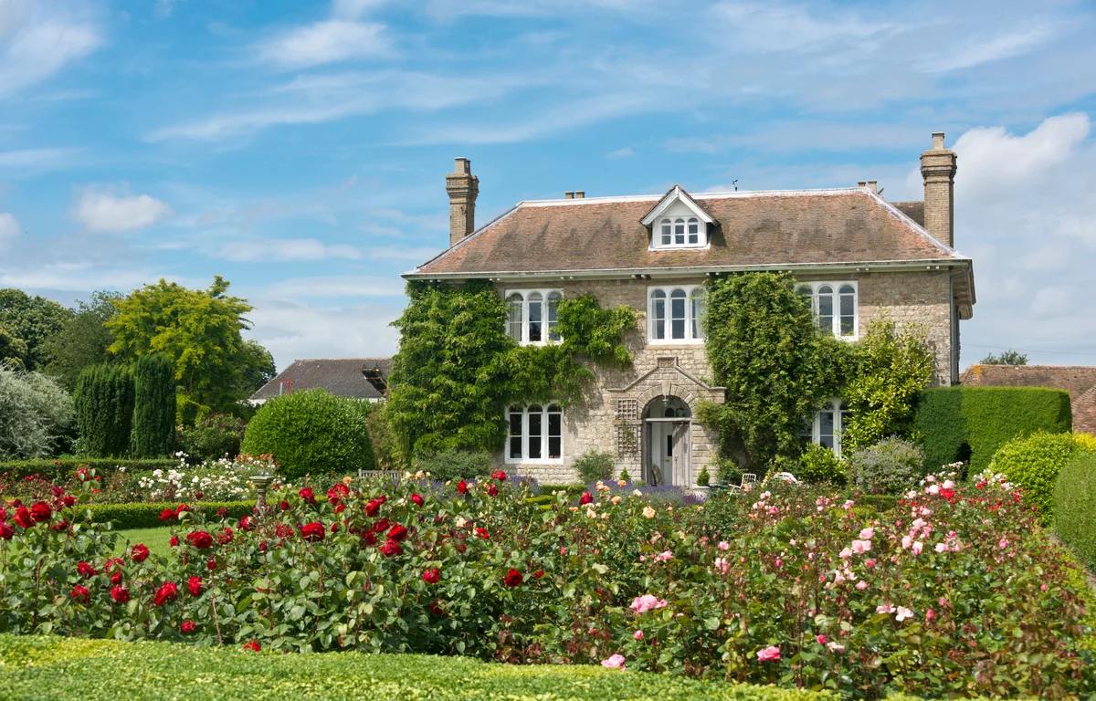 Beautiful English cottage with flowers lining the front