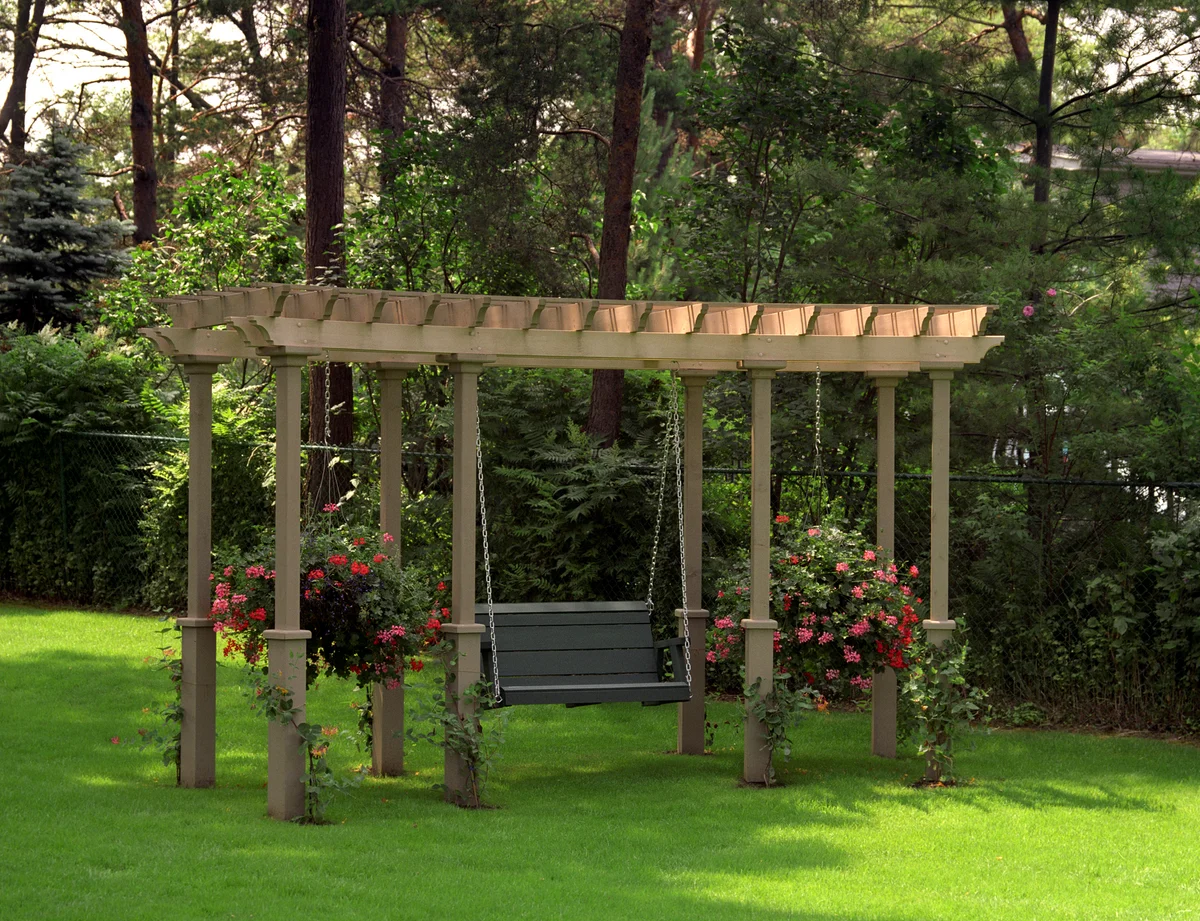 Garden swing under wooden pergola in garden