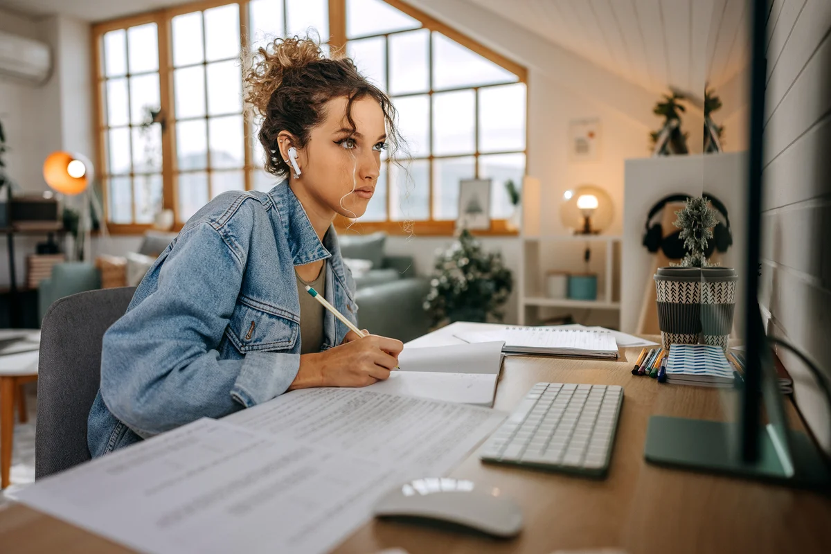 Teen girl studying at desk in cool looking room