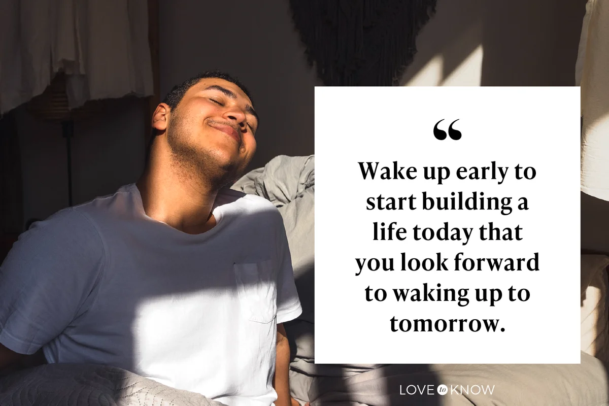 Smiling man enjoying sunlight sitting on bed at home