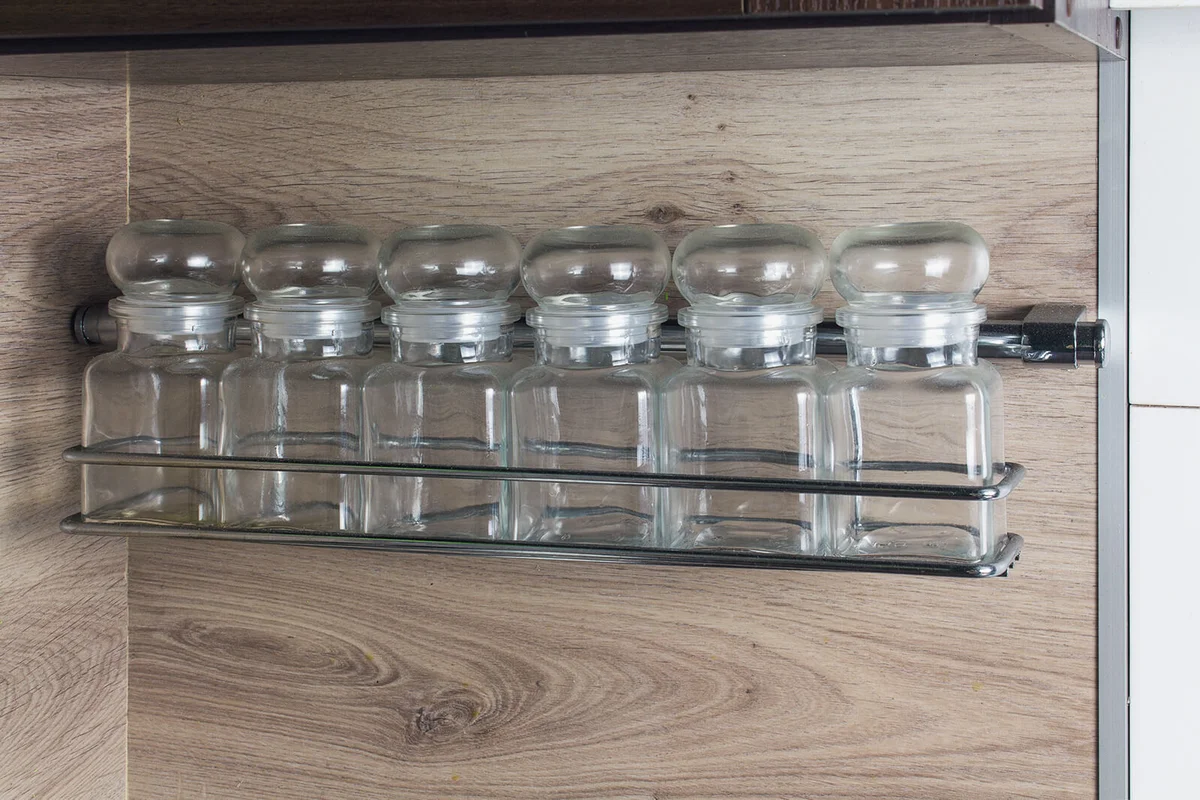 Glass spice jars on a shelf