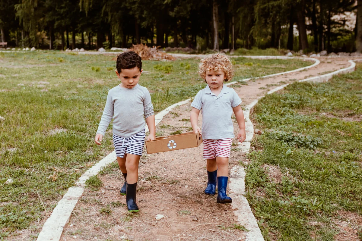 Boys carrying recyclable cardboard box