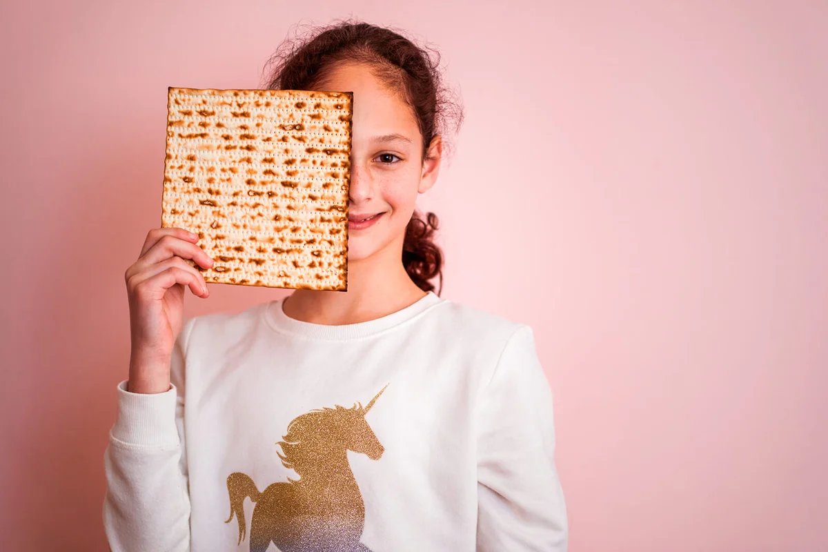 Young girl holding matzah or matza